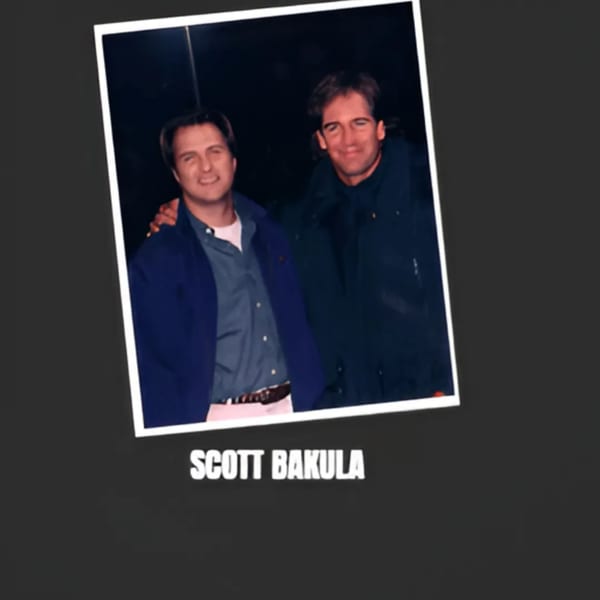Two men, one identified as Scott Bakula, smiling in a dark setting, possibly at Bessinger's BBQ.