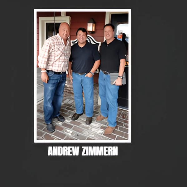 Three men, including Andrew Zimmern, standing outside Bessinger's BBQ restaurant.