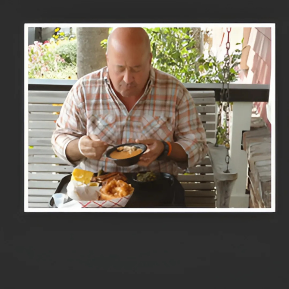 A man in a plaid shirt eats a bowl of chili with a side of BBQ at Bessinger's.