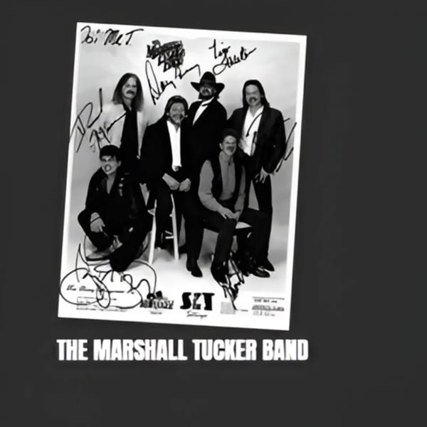 Black and white autographed photo of The Marshall Tucker Band, a group of six men.